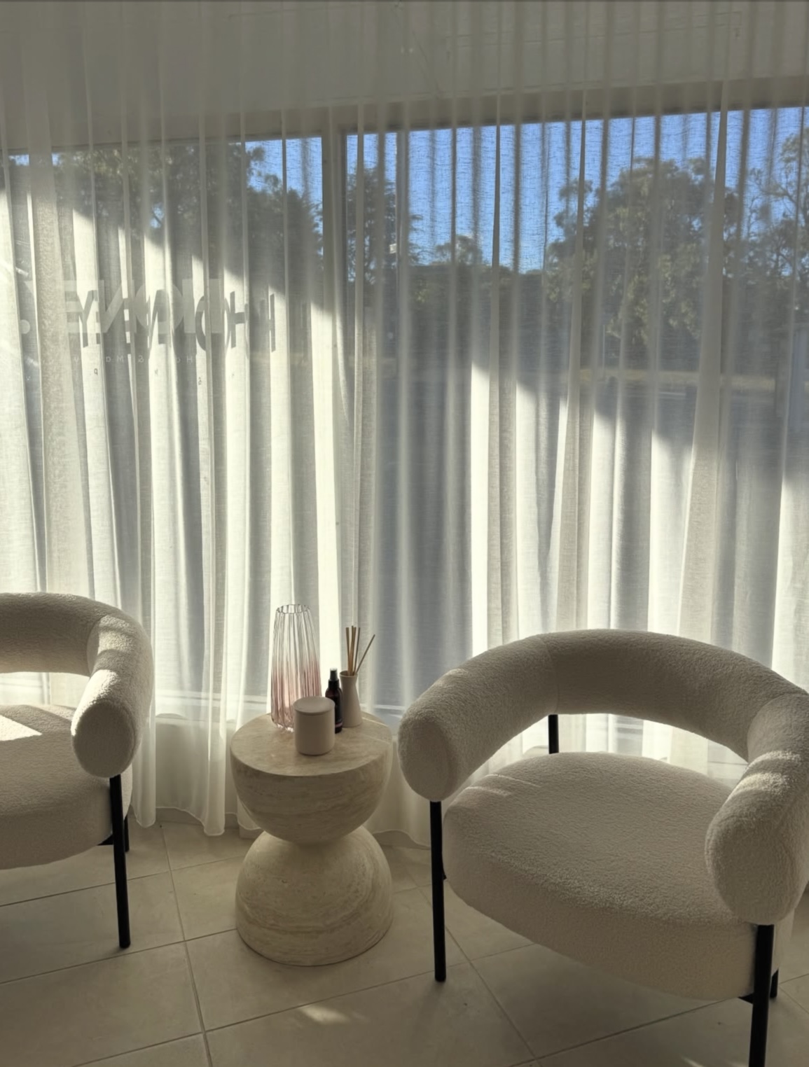 Boucle lounge chairs by the window